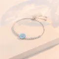 Pulsera de tenis ajustable de plata con circonitas cúbicas y flor esmaltada azul claro. - Pulsera Ajustable de Flor Azul (TS0281) / Plateado
