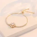 Pulsera de tenis de circonita cúbica ajustable dorada con colgante de estrella brillante. - Pulsera de Strass en Racimo de Flores (TS0286) / Dorado