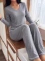 Detailed view of the women's cozy grey V-neck long sleeve pajama set worn by model. - S / Top And Bottom / Dark Gray