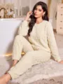 Close-up detail of women's cozy thickened fleece loungewear set in soft cream tone. - Apricot