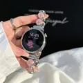 Close-up of metal four-leaf clover smartwatch strap with pink flower accents, elegant design. - Silver Pink