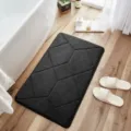 Dark grey memory foam bath mat with geometric pattern, soft absorbent shower rug for home. - Black