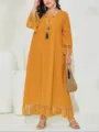 Detailed view of a stylish mustard yellow maxi dress with fringe hem and long sleeves. - 4XL / Dresses / Yellow
