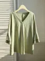 Detail of the elegant plus size V-neck top with floral jacquard and layered sleeves. - Color 18