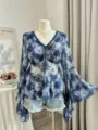 Blue printed V-neck blouse with long bell sleeves and delicate tie front detail scene. - Color 21