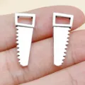 Mini metal saw shaped charms in silver tone, perfect for DIY jewelry making, bracelets and keychains. - Saw (8524)