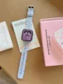 Detailed view of the colorful plaid silicone watch strap with cute cartoon rabbit dial screen. - Compatible: (S10/11 Gen 42mm) / Blue Polka Dot Plaid