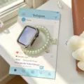 Gros plan sur le boîtier Apple Watch en strass et le bracelet téléphone vert avec charms papillon. - Taille Personnalisée: 18mm / Vert