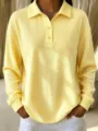 Detail view of the women yellow waffle knit polo long sleeve top with buttons and casual fit. - Yellow