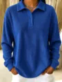 Detailed shot of a casual blue waffle knit polo shirt with button collar and long sleeves. - Dark Blue