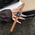 Detailed close-up of brown lizard pattern genuine leather watch strap with gold buckle. - For S10/11 42mm 38mm/40mm/41mm Universal / Brown Gold Buckle - Lizard Pattern