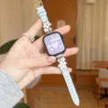 Close-up detail of light blue leather watch strap featuring elegant silver metal floral charms. - Blue - Silver Buckle White Flower