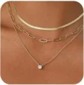 Collana dorata multistrato con ciondolo in zircone delicato e catene per uno stile elegante. - Tre Pezzi Oro