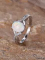 Elegant sterling silver cross twisted ring featuring a glowing oval white opal and sparkling stones. - Size 5 / Silver White Opal