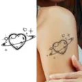 Temporary tattoo sticker featuring a cosmic heart planet design with rings and stars for body art. - Heart Planet (HA012) / 8x8cm