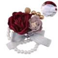 Elegant wedding wrist corsage with fabric roses, faux pearls, and silver bow accessory. - Wrist Corsage / Burgundy