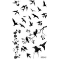 Temporary tattoo sticker sheet featuring stylish black flying birds and floral vine designs. - SS242