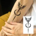 Temporary tattoo sticker featuring a sword with wings and crescent moon design for arm body art. - HS125 / 9.8x5.8cm