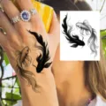 Temporary tattoo sticker featuring a black and white koi fish design for arm or body art. - HM080 (Double Fish)