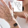 Adesivo per tatuaggio floreale temporaneo con un delicato design a ramo in bianco e nero. - HM145 / 10x8cm