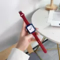 Red silicone slim waist watch strap with blue protective case detail view for Apple Watch series. - 49mm / Burgundy + Dark Blue Case