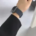 Detailed view of grey braided elastic watch band worn on wrist, compatible style. - 38mm/40mm/41mm / Gray