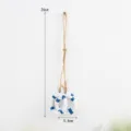 Detail shot of a Mediterranean style wooden lifebuoy hanging ornament with hemp rope. - Lifebuoy String