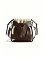 Detailed view of canvas bucket bag featuring brown leather cage overlay and drawstring. - Coffee