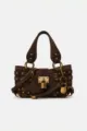 Detailed view of the dark brown suede shoulder bag featuring vintage brass hardware and a padlock. - L / Coffee Suede