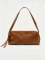Brown faux suede shoulder bag detail showing soft texture, long strap and metal buckle. - Brown Suede