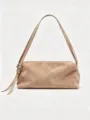Detail view of casual minimalist suede shoulder bag with fine strap and elegant metal buckle. - Apricot Suede