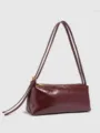 Burgundy patent leather shoulder bag detail, featuring long double straps and gold zipper. - Wine Red PU