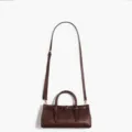 Niche design brown leather handbag with buckle detail, adjustable shoulder strap and top handles. - Brown