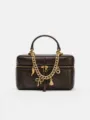 Detailed shot of trendy brown leather vanity box bag with chic gold chain and cute metal charms. - Coffee
