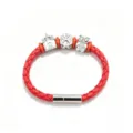 Detail view of red braided leather bracelet with silver magnetic clasp and cute metal charms. - Red Christmas Style
