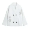 Close-up of white knitted cardigan with exquisite beading, V-neck and wooden buttons detail. - S / Tops / White