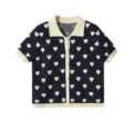 Detailed close-up view of the heart jacquard knit cardigan with contrast lapel and buttons. - S / Tops / Navy Blue