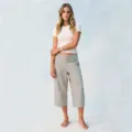 Detailed view of casual loose cropped pants with studded folded waistband and white top on model. - S / Gray