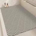 Detailed view of modern minimalist grey bath mat with white wave pattern, non-slip PVC material. - 45x70cm / Wave Cycle