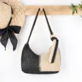 Detail view of black white woven straw shoulder bag, casual chic beach purse with knot detail. - Beige + Black