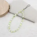 Close-up detail of iridescent star bead phone strap accessory, featuring colorful glossy star charms. - Light Yellow Star