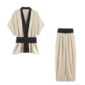 Details view of the chic two-piece set featuring a contrast lapel wrap top and wide-leg trousers. - XS / Top And Bottom / Off White