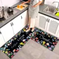 Kitchen floor mat detail showing floral pattern and English text in home setting. - Black Colorful Floral