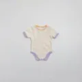 Detailed view of baby cotton ribbed short sleeve romper with colorful specks and contrast trim. - 66cm / Beige Apricot