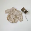 Detailed view of baby girl long sleeve romper, cute ruffles and delicate lace trim design. - 66cm / Apricot