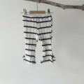 Cute infant baby black and white striped ribbed flared pants with sweet bow hem details. - 66 / Bottoms / Black and White Stripe