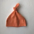 Orange top knot baby hat, soft cotton newborn beanie, cute infant headwear accessory. - One Size / Orange Hat