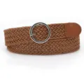 Detailed view of women braided waist belt with round metal buckle and brown finish. - Camel