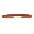 Close-up detail of women's brown elastic slim belt with gold metal buckle for dresses. - Camel