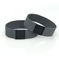Detailed shot of elastic high heel shoe straps in gray with black leather patch connectors. - Dark Gray Pair